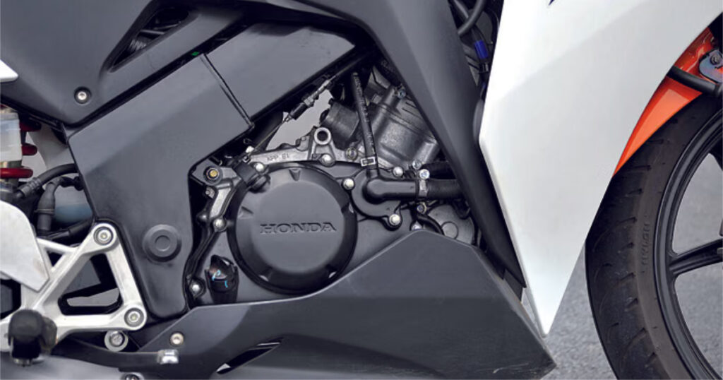 A detailed shot of the 149cc engine where the 2026 Honda CBR150R features liquid cooling and DOHC architecture.