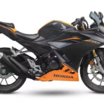 The front assembly of the bike where the 2026 Honda CBR150R features gold upside-down forks and aggressive dual LED headlights.