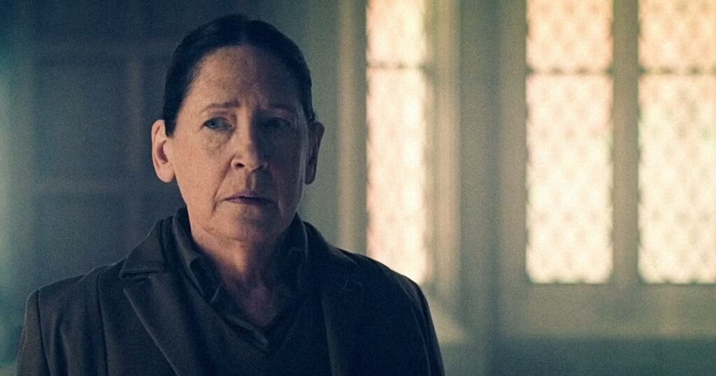 Aunt Lydia looking out a window in a still from the show before The testaments episode 7 release date.