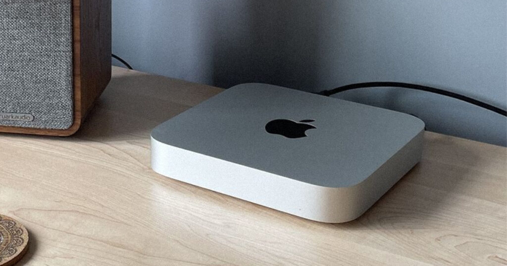 A high-quality shot of the silver Mac Mini on a wooden desk, symbolizing the Apple cheapest Mac mini discontinued news.